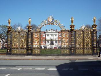 Empty road against closed gates