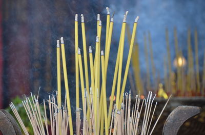 Close up burning joss-sticks in chinese shrine.