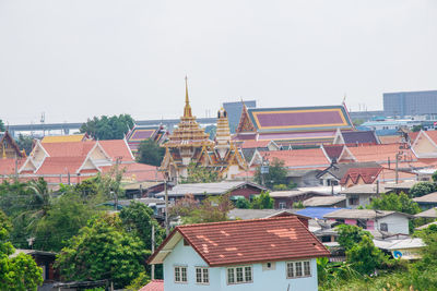 Houses in city against clear sky