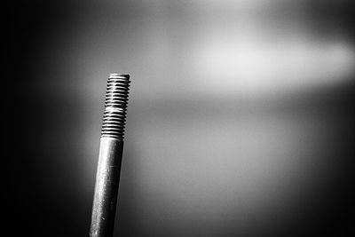 Close-up of metallic object against wall