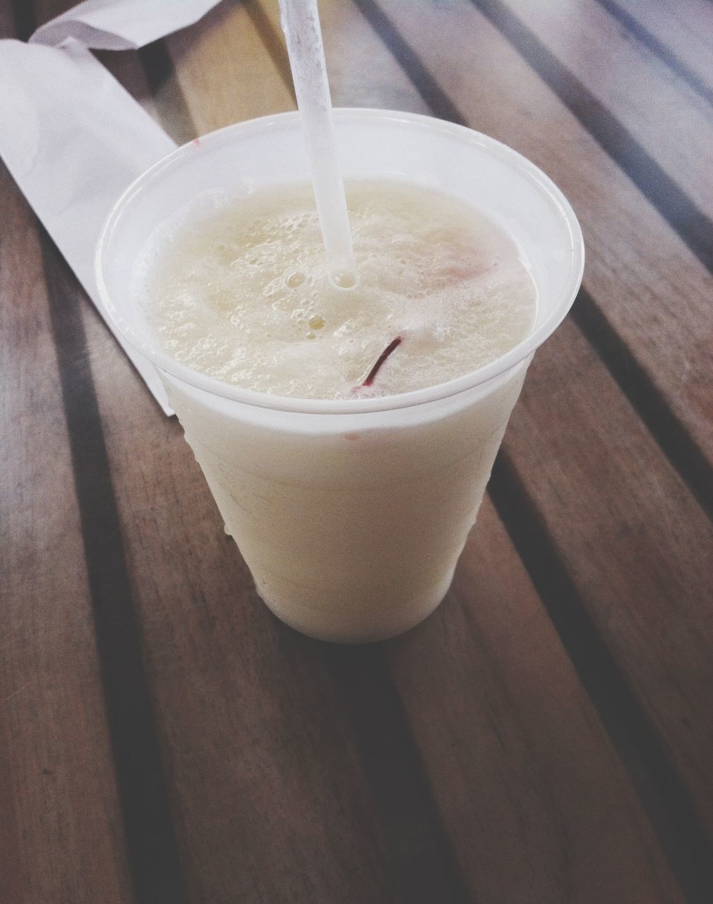 food and drink, drink, refreshment, freshness, table, indoors, close-up, still life, drinking glass, high angle view, frothy drink, drinking straw, healthy eating, no people, wood - material, coffee - drink, day, focus on foreground, water, sunlight