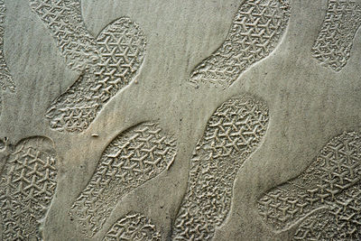 Full frame shot of footprints on sand