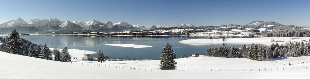 Scenic view of snow covered mountains against sky