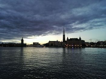 Scenic view of river against cloudy sky