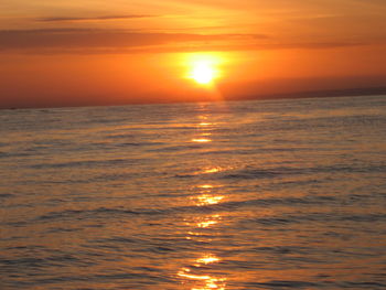 Scenic view of sea against orange sky