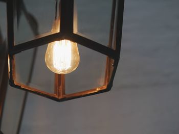 Close-up of illuminated lamp against sky