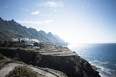 Scenic view of sea and mountains against sky