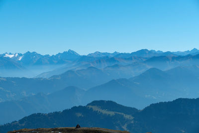 Scenic view of mountains against clear blue sky