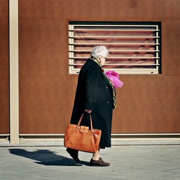 WOMAN STANDING AGAINST WALL