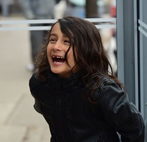 Happy girl standing outdoors