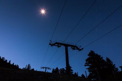 Low angle view of electricity pylon against sky