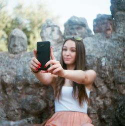 Woman photographing through smart phone