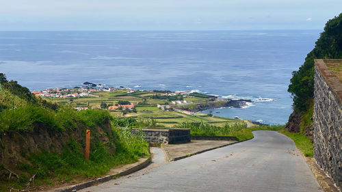 Road by sea against sky