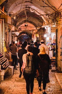 Rear view of people walking in market