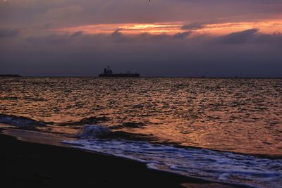 Scenic view of sea against orange sky