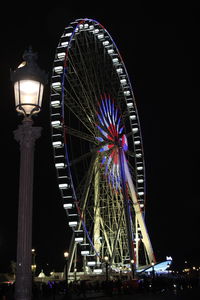Low angle view of illuminated ferris wheel at night