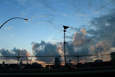 Low angle view of bridge against cloudy sky