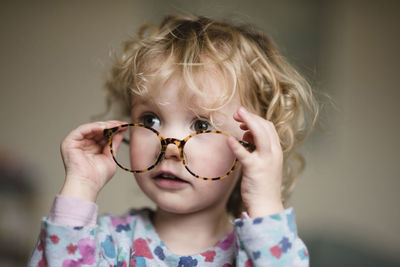 Close-up of girl with eyeglasses at home