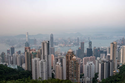 Aerial view of buildings in city against sky