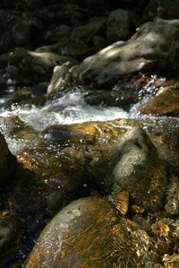 Close-up of stream flowing through rocks