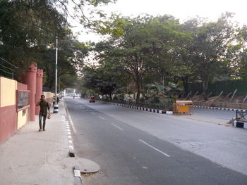 Rear view of a woman walking on road