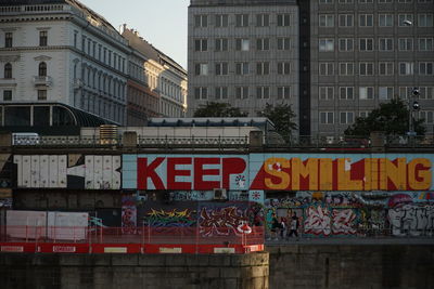 Text on road against buildings in city