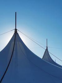 Low angle view of sailboat against clear blue sky