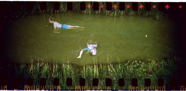 Full length of girl swimming in water at night