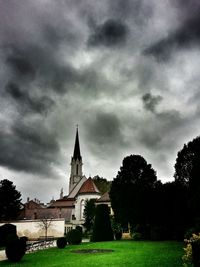 Built structure on landscape against cloudy sky