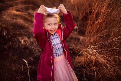 Spring girl with a paper boat