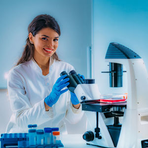 Biology student researcher looking through the microscope