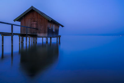 Built structure in sea against blue sky