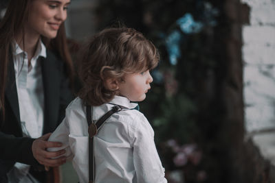 Rear view of mother and daughter outdoors