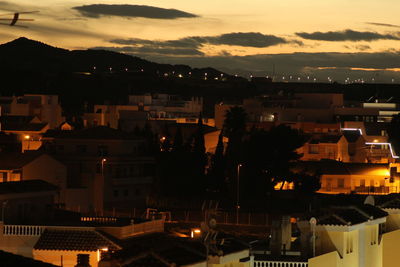 High angle view of illuminated buildings against sky at sunset