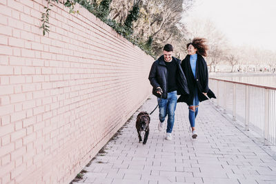 Full length of woman walking on footpath in winter