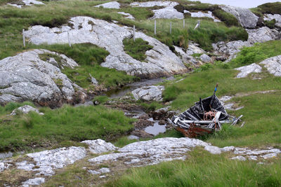 High angle view of abandoned boat on grassy field