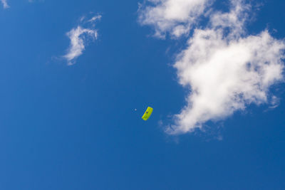 Low angle view of kite flying against blue sky