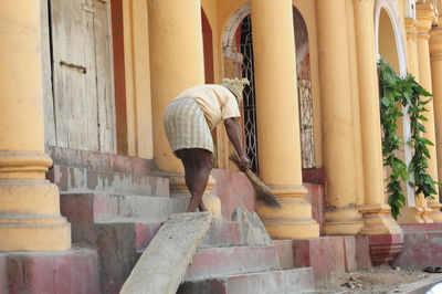 Woman standing on staircase of building