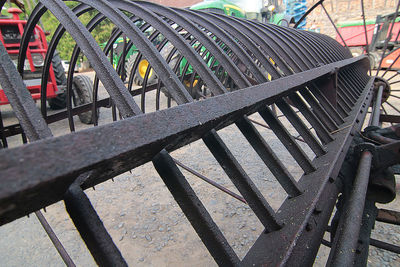 Close-up of empty bench by railing