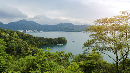 Scenic view of sea and mountains against sky