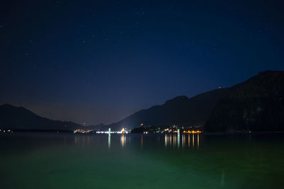 Scenic view of lake against sky at night