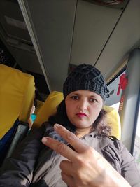 Portrait of woman sitting on seat in bus