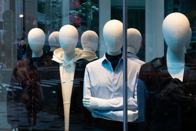 Mannequin in glass window in store