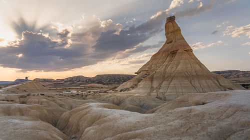 Scenic view of rock formation against sky during sunset