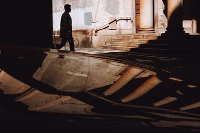 Side view of man walking on staircase