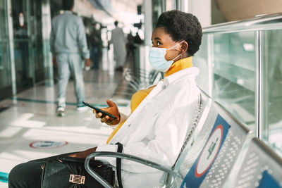 Man using mobile phone while sitting in bus