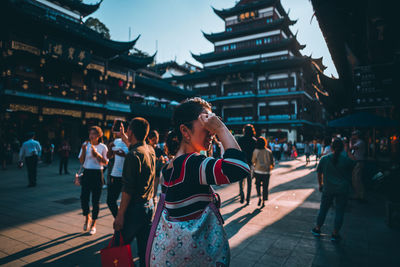 Group of people walking in front of buildings