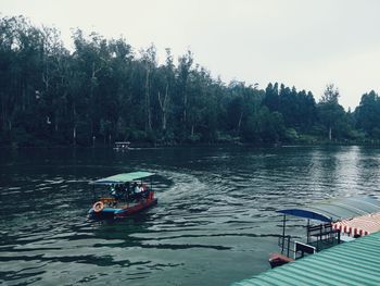 Boat sailing in river against sky