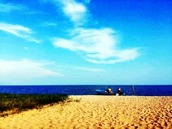 Scenic view of beach against cloudy sky