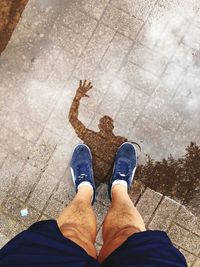 Low section of man standing on footpath